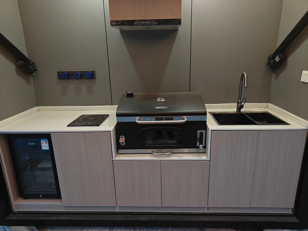Close-up of outdoor kitchen with pizza oven and induction hob